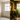 Comparison of an empty room and a decorated living room with plants and furniture.